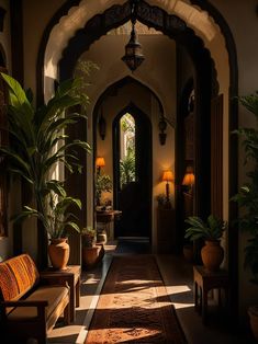 an archway leading to a hallway with potted plants and lamps on either side of it