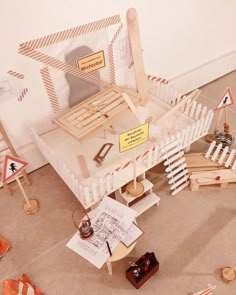 an assortment of wooden toys and construction signs on the floor