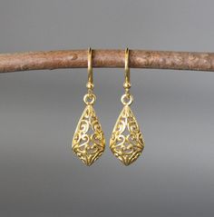 "24k matte gold vermeil filigree charms dangle from 18k gold vermeil balled earwires. Wear these elegant earrings everyday as they complete any outfit. Gold filigree charms: 9x19mm Total length of earrings: 1 1/8\" All gold is gold vermeil. This earrings are available in bright silver... www.etsy.com/listing/630528036/silver-filigree-earrings These earrings are also available in oxidized silver... www.etsy.com/listing/688867970/silver-filigree-earrings As the owner, maker, designer, and curator Luxury Gold Danglers With Elegant Design, Luxury Gold-plated Gold Danglers, Luxury Gold Danglers In Sterling Silver, Luxury Elegant Gold-plated Danglers, Luxury Traditional Yellow Gold Danglers, Gold Filigree Sterling Silver Earrings, Gold Filigree Earrings As Gift, Gold Teardrop Earrings With Intricate Design, Gold Filigree Earrings For Gift