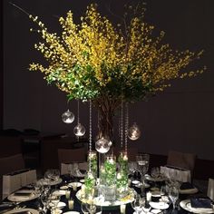 there is a table set with plates and flowers in the vases on the table