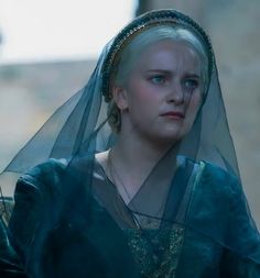 a woman with blonde hair and blue eyes wearing a veil over her head in a scene from game of thrones