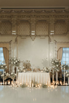 an elegant wedding setup with candles and flowers