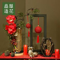 a table topped with red candles and decorations