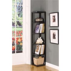 a corner shelf with pictures and books on it