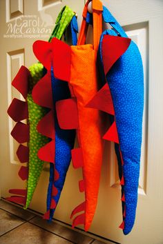 several colorful kites hanging on a white door