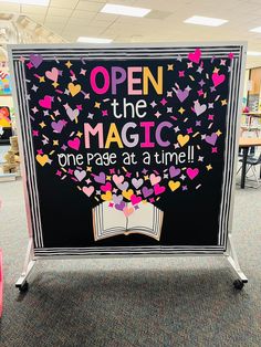 an open the magic one page at a time sign with hearts and stars on it