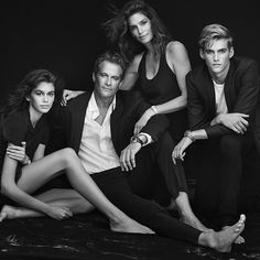 four people posing for a black and white photo