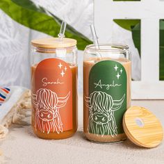 two jars filled with liquid sitting on top of a table next to a wooden lid