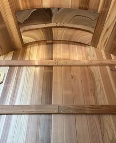 the inside of a wooden room with wood paneling and metal studs on it