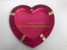 a pink heart shaped tray with gold trim