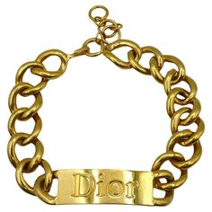 CHRISTIAN DIOR by JOHN GALLIANO massive gold tone runway necklace featuring curb links and ID tag embossed DIOR. CHRISTIAN DIOR Ready-To-Wear Fall 2000-2001. Hook clasp closure. Embossed DIOR ®. Indicative measurements : adjustable length from approx. 40 cm (15.75 inches) to approx. 45 cm (17.72 inches) / link width approx. 2.5 cm (0.98 inch) / ID tag approx. 6.3 cm (2.48 inches) x 2.4 cm (0.94 inch). Material : Gold tone metal hardware. NOTES - This is a preloved vintage item, therefore it might have imperfections. - Colors may differ slightly from actual product appearance due to differences in lighting conditions. - As a buyer, you are fully responsible for customs duties, other local taxes and any administrative procedures related to imports into the country of destination. Dior Ready To Wear, Dior By John Galliano, Runway Necklace, Hook Clasp, Gold Tone Necklace, John Galliano, Id Tag, Metal Hardware, Gold Tone Metal