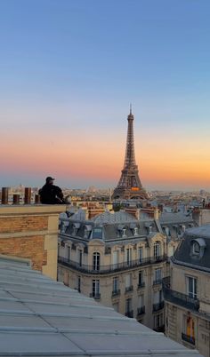 the eiffel tower towering over paris at sunset