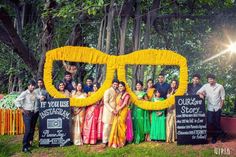 a group of people standing next to each other in front of a sign