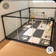 a child's playpen with black and white tiles on the floor, including toys