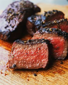 some steaks on a cutting board with seasoning