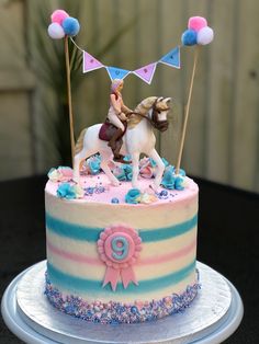 a birthday cake with a horse and rider on top