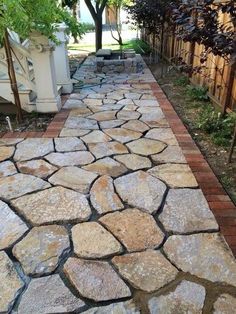 a stone path in the middle of a yard