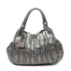 Prada Shoulder Bag Striped Tote In Bronze Pleated Calfskin Leather/Nylon Canvas And Silver Hardware. The Product Is In Excellent Condition (A). Dimension: 40*27*11cm Sku: Aaz5647 Serial Number: Br3994 Accessories Included: None Delivery: We Have A 5 To 7 Business Days Delivery Policy, Hassle-Free And Duties/Tariffs Included! Brandco Paris Finds Rare And Top Condition Items At Great Deals, They Are Worth Your Patience! Shop With Confidence - All Brandco Paris Items Are Carefully Selected And Auth Luxury Metallic Silver Shoulder Bag, Designer Silver Leather Shoulder Bag, Chic Leather Bag With Silver-tone Logo, Designer Silver Leather Bags, Elegant Metallic Silver Leather Shoulder Bag, Luxury Metallic Bag With Silver-tone Logo Plaque, Bags Prada, Prada Shoulder Bag, 5 To 7