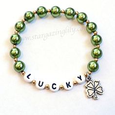 "St. Patrick's Day LUCKY charm bracelet with silver tone 4 leaf clover shamrock charm. Green glass pearls gold accent spacers. You can order this with LUCKY on in or Personalize it. ORDER INFO - This bracelet is sized to order. Please indicate the personalization info or if you would like it as pictured in the \"notes to seller\" box. See more Stargazinglily adult jewelry here: http://www.etsy.com/shop/stargazinglily?section_id=5359087" St Patrick’s Day Bracelets, Shamrock Jewelry, St. Patrick's Day Diy, St Patric, Blarney Stone, Shamrock Earrings, Secret Pal, Lucky Charm Bracelet, Beads Accessories