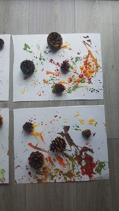 four pieces of paper with pine cones and paint splattered on them