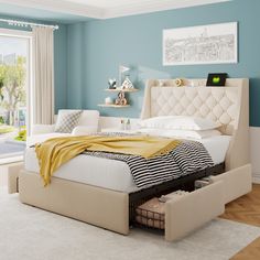 a bedroom with blue walls and white furniture