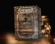 mason jar save the date card with string lights on it and wooden backing in front