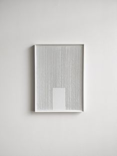 a white square is mounted on the wall