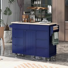 a blue kitchen island with wine bottles on it