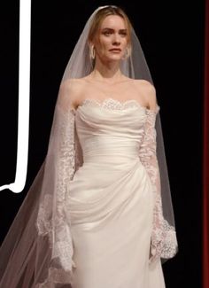 a woman in a white wedding dress with a veil on her head and the words j