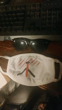 a pair of sunglasses sitting on top of a desk next to a keyboard and mouse