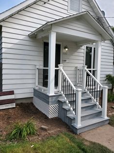 a white house with a porch and stairs