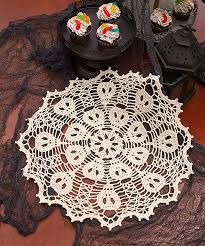 a lace doily with cupcakes on it