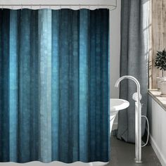 a bathroom with a blue shower curtain next to a bathtub and sink in front of a window