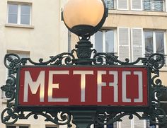 a sign that says metro on it in front of a building