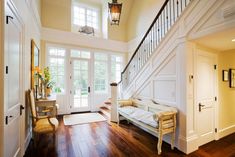 an entry way with stairs and a chandelier