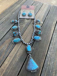 New without tags JEWELRY TYPE : Necklaces MAIN STONE : Turquoise TRIBAL AFFILIATION : Navajo METAL : Sterling Silver FEATURED REFINEMENTS : Navajo Pearls ARTISAN : Kathleen Chavez Absolutely STUNNING ! Royston Turquoise and Sterling Necklace is 20 inches long with a 3 inch drop and quite a beauty. Beautiful by itself or layered with your favorites. Matching Dangle Earrings are 1 3/4 inches long. Signed by the Talented Artist Kathleen Chavez & Stamped Sterling. Thank you for looking at our it Blue Teardrop Western Style Jewelry, Southwestern Style Teardrop Gemstone Jewelry, Southwestern Teardrop Gemstone Jewelry, Western Style Turquoise Gemstone Jewelry, Untreated Blue Western Jewelry, Rustic Blue Sterling Silver Jewelry, Southwestern Sterling Silver Hand-strung Jewelry, Southwestern Hand-strung Sterling Silver Jewelry, Southwestern Style Hand-strung Sterling Silver Jewelry