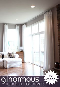 a living room filled with furniture and windows