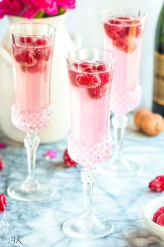 two glasses filled with raspberry champagne