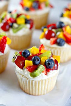 small cupcakes with fruit toppings on them