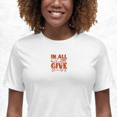 Embrace an attitude of gratitude with our "In All Things Give Thanks" T-Shirt. This inspiring tee features the uplifting message from 1 Thessalonians 5:18, reminding us to be thankful in every situation. Whether you're celebrating blessings or finding strength in challenges, this shirt serves as a daily reminder to appreciate the good in all aspects of life. Crafted from soft, durable fabric, this T-shirt is perfect for casual wear, spiritual gatherings, or as a thoughtful gift to spread positivity and faith. Pair it with your favorite jeans or casual bottoms to create a look that's both stylish and meaningful. Discover this unique and meaningful design at PootsyJ on Etsy: pootsyj.etsy.com. * 100% combed and ring-spun cotton * Athletic heather is 90% cotton, 10% polyester * Other heather c Inspirational Crew Neck T-shirt For Fall, Inspirational Graphic Print T-shirt For Fall, In All Things Give Thanks, Finding Strength, An Attitude Of Gratitude, All Things, Casual Bottoms, 1 Thessalonians, Attitude Of Gratitude