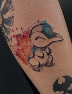 a tattoo on the leg of a person with a cartoon character in front of it