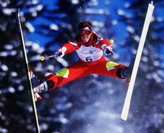 a man flying through the air while riding skis