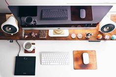 an overhead view of a desk with two computer monitors, keyboard, mouse and speakers