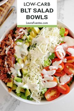 a white bowl filled with salad topped with cheese and dressing next to a baguette