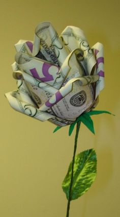 a flower made out of money sitting on top of a table