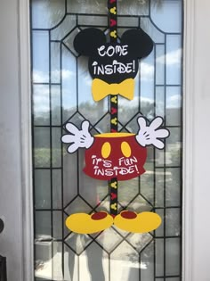 a mickey mouse door hanger with some words on it and the word come inside is fun inside