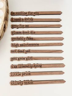 six wooden spoons with words written on them