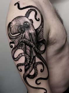 an octopus tattoo on the left arm and shoulder is shown in black ink, it looks like