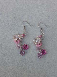 Beaded Flower Earrings in Shades of Pink Hand beaded flowers connected to create this fun pair of earrings. They are approximately 2 1/4 inches. Pink Beaded Drop Flower Earrings, Dangling Bead Flower Earrings For Party, Party Flower Earrings With Dangling Beads, Pink Dangle Flower Earrings With Colorful Beads, Pink Flower Earrings With Dangling Round Beads, Pink Dangling Beads Flower Drop Earrings, Pink Flower Jewelry With Dangling Beads, Pink Flower-shaped Jewelry With Dangling Beads, Pink Dangling Bead Flower Earrings