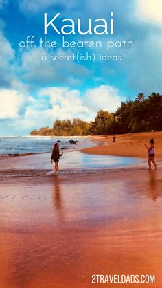 two people are walking on the beach in front of the water and clouds, with text that reads kauai off the beaten path